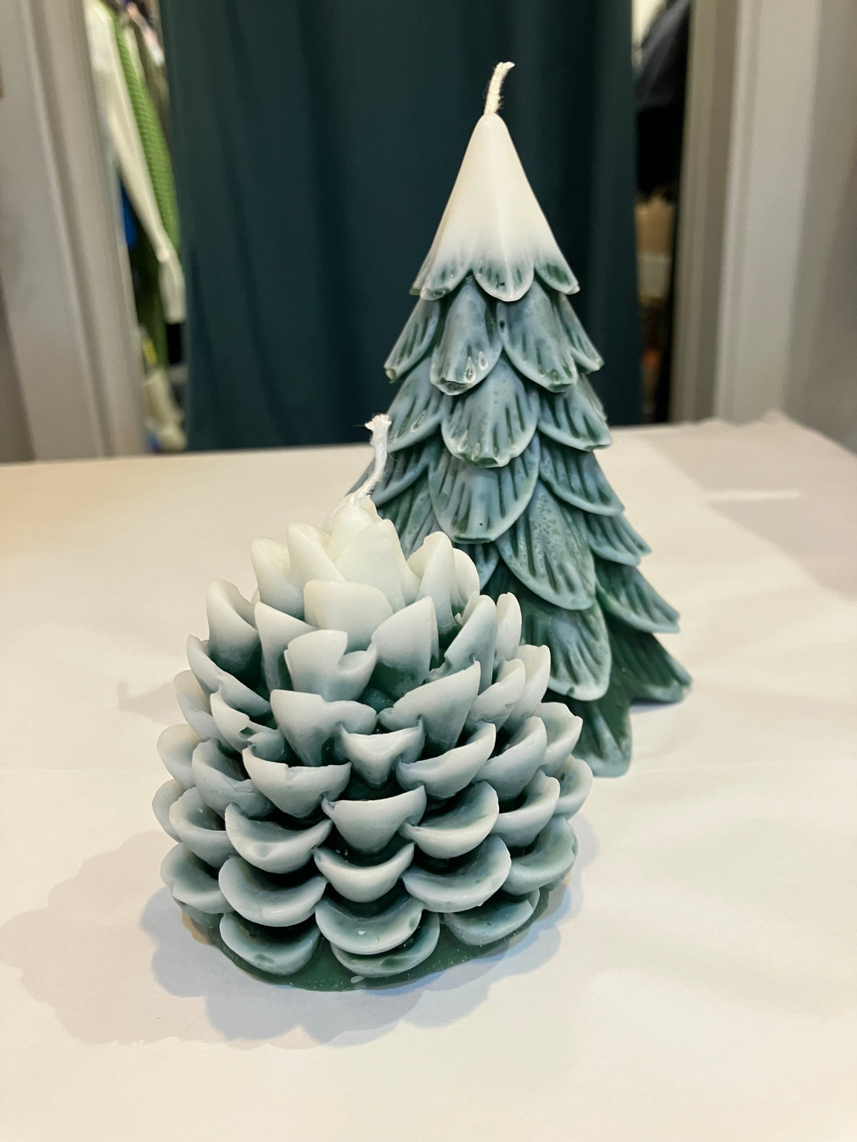 Snowy cream Christmas tree in forest pinecone scent