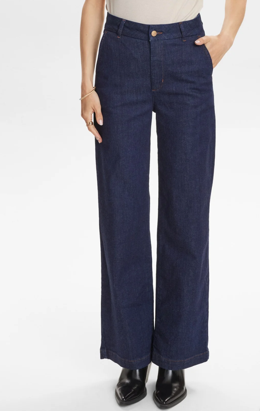 Dark blue straight leg jeans on a white background