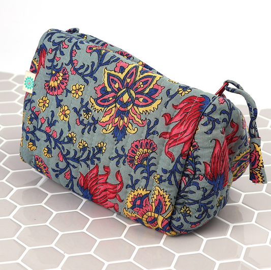 Fabric pouch with colorful floral pattern on a hexagonal tile background