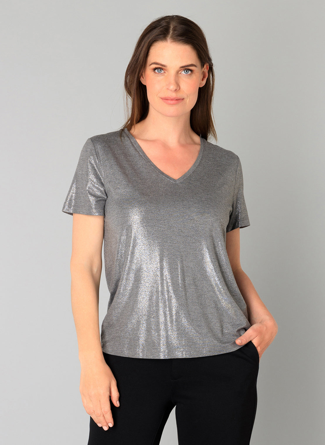 Woman wearing a gray metallic V-neck t-shirt against a plain background