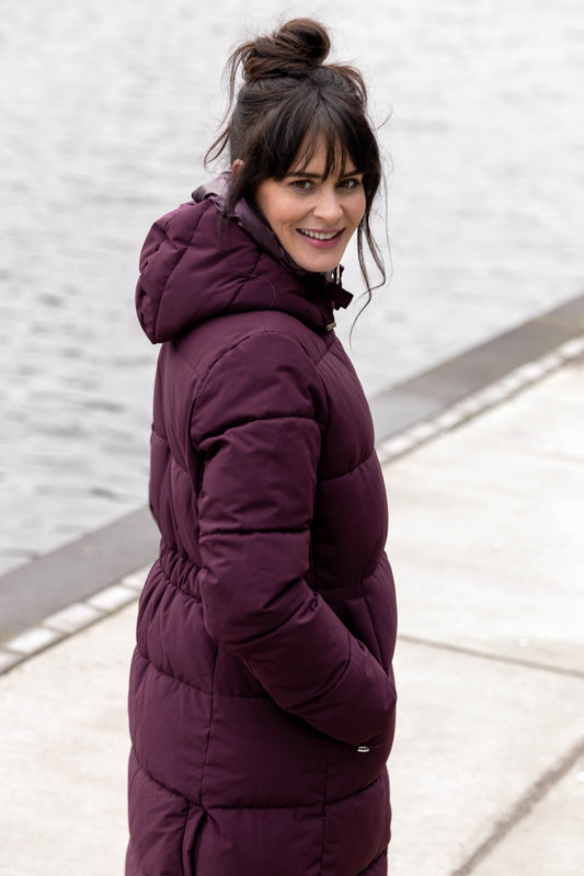 Woman wearing a burgundy puffer coat 