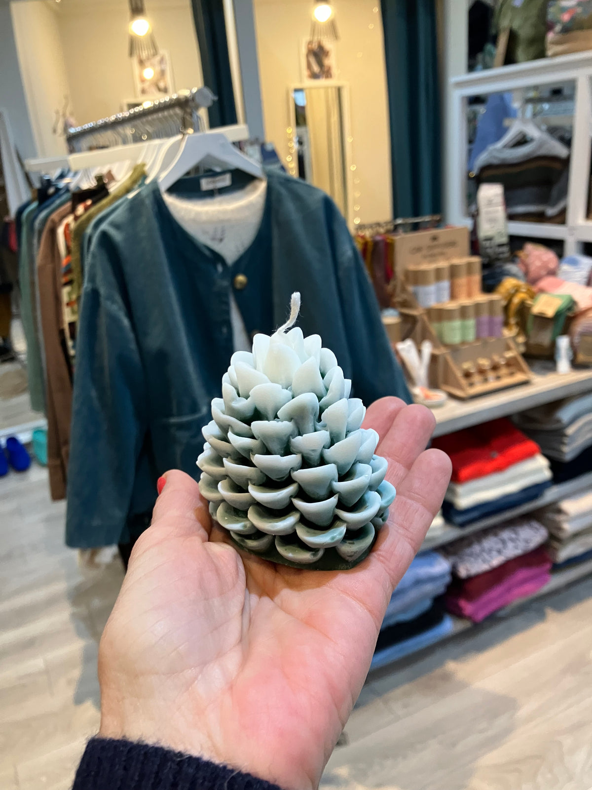 Snowy cream Christmas tree in forest pinecone scent