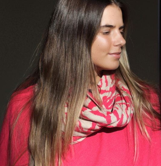 Woman wearing a pink snood with a geometric pattern 